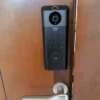 Technician installing a Eufy smart lock on a front door in Dubai