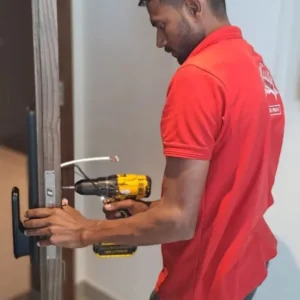 Smart door lock installation in Dubai by certified technician using power drill