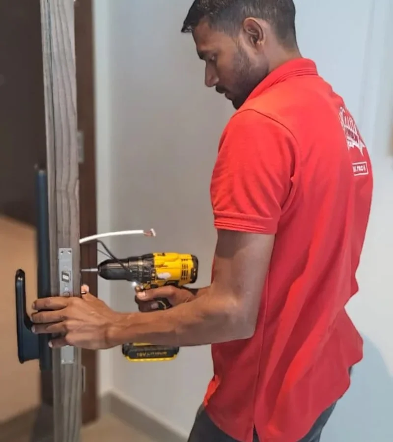 Smart door lock installation in Dubai by certified technician using power drill
