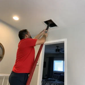 AC duct cleaning in Dubai technician cleaning ceiling air duct vent